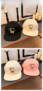 Close-up of the duck embroidery and decorative rope detail on a canvas baseball cap