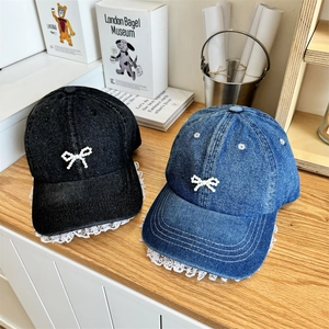 Denim baseball caps with lace edges and pearl bow detail in black and dark blue