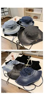 Detailed flat lay of washed denim bucket hats in three colors with adjustable drawstrings