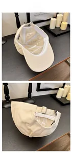 Detailed view of beige cotton baseball cap featuring metal buckle and sturdy inner structure
