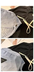 Detail of washed denim bucket hat with triangle logo and cotton drawstring cord
