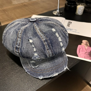 Vintage dark blue washed denim newsboy cap with distressed details and frayed edges