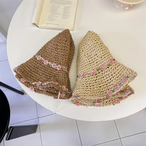 Handcrafted crochet straw hats with pink lace flower accents in beige and tan colors