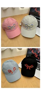 Detail of baseball caps with embroidered bows and Color Circle Club lettering designs