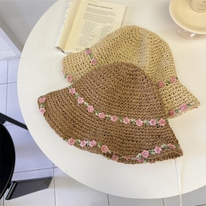 Foldable handmade straw bucket hats with pink floral lace embroidery in beige and brown