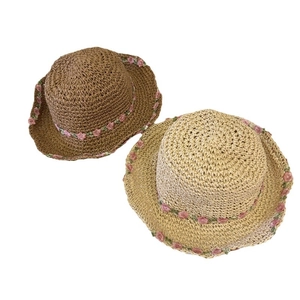 Straw sun hats in beige and brown with pink floral embroidery for summer beach vacation