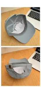 Detailed view of the adjustable metal buckle and interior lining of the blue baseball cap