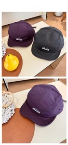 Detail of five-panel quick-dry nylon hats in purple and grey with outdoor embroidery