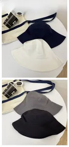 Flat lay tile display of cotton canvas bucket hats in navy, white, grey, and black colors