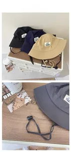 Detail view of quick-dry bucket hat featuring adjustable wind cord and Vantage logo patch