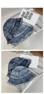 Detail view of washed denim bucket hats with checkered texture and frayed edges