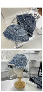 Close-up of vintage washed denim bucket hats in light and dark blue with frayed edges