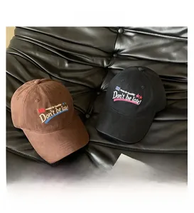 Detailed close-up of 'Don't be late!' 3D embroidery on soft brown suede baseball cap