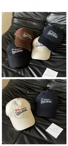 Detail of embroidered American vintage baseball caps in brown and navy on leather
