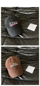 Close-up of cotton baseball caps with Don't Be Late embroidery and star patterns