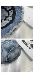Detail of frayed edge denim bucket hat with internal sweatband and adjustable drawstring