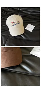 Detail view of vintage baseball caps with Don't be late embroidery and contrast stitching