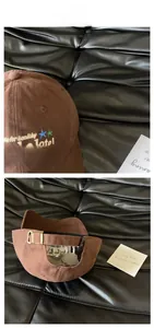 Detail showing vintage brown baseball cap with star embroidery and metal buckle strap