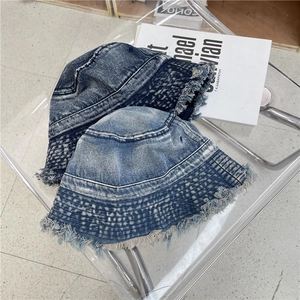 Vintage washed denim bucket hats in dark and light blue with frayed edges and fringe detail