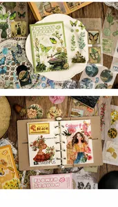 Detailed close-up of vintage forest themed scrapbooking stickers with butterflies and flora