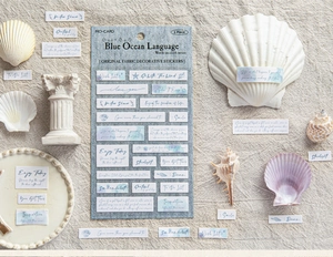 Macro view of Blue Ocean Language fabric stickers with ocean quotes on beige linen