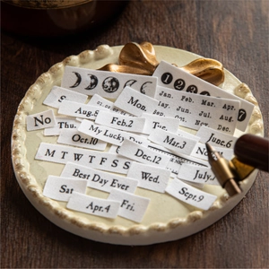 Vintage style white fabric labels with black date and text prints for DIY journaling