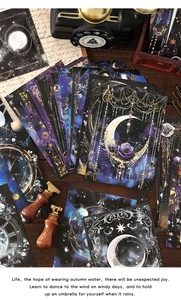 Close-up of vintage celestial scrapbooking paper with moon and star gold foil details