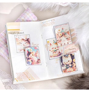 Detail of happy kitten themed washi tape and stickers on dotted journal pages