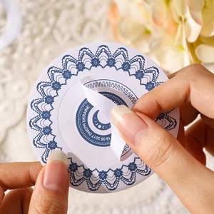 Lace-bordered vintage floral sticker with blue lunar phase design for scrapbook journals