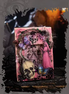 Close-up of gothic scrapbooking paper featuring skulls, butterflies, and castle motifs