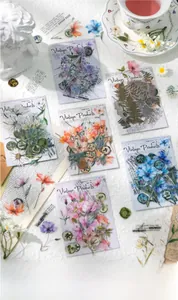 Close-up of vintage floral stickers for scrapbooking featuring transparent botanical designs