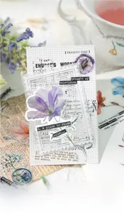 Macro detail of vintage purple floral stickers and stamp-shaped papers for journaling