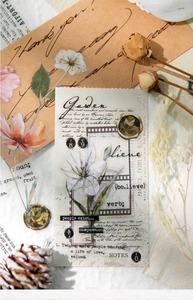 Macro view of vintage PET floral stickers and letter slogans for scrapbook decoration