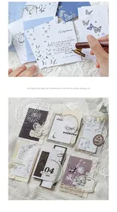 Macro view of vintage relief memo pads with silver butterfly motifs and letterpress details