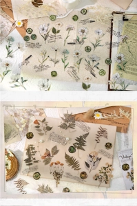 Close-up of vintage floral PET stickers and dictionary definitions for scrapbooking