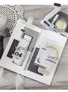 Detail of vintage junk journal supplies with silver foil relief and floral paper elements