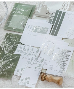 Detail of vintage plant stationery with silver foil stamping and embossed botanical patterns