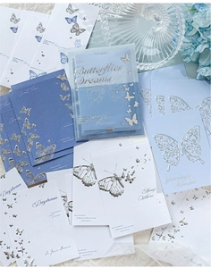 Close-up of vintage butterfly paper with silver foil stamping and embossed texture