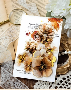 Close-up of vintage floral stickers with gold foil details and artistic female portraits