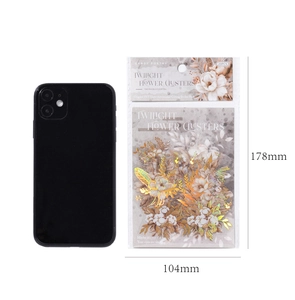 Detailed view of Twilight Flower Clusters PET stickers with gold stamping on white surface