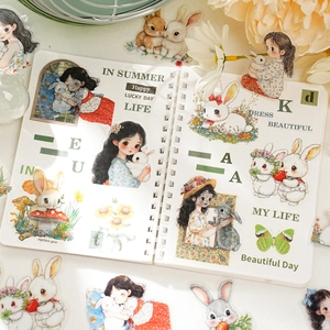 Cartoon girl and white rabbit stickers for DIY journaling on a white notebook
