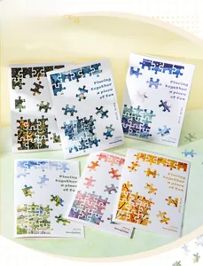 Detail of DIY scenery scrapbooking cards with puzzle elements and seasonal landscapes