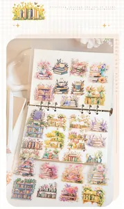 Close-up of watercolor book and floral stickers displayed in a creative journal