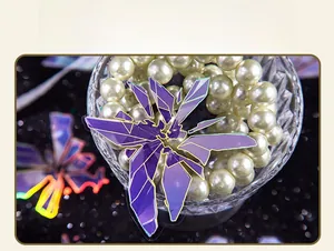 Close-up of holographic purple geometric stickers with gold foil over pearl accessories
