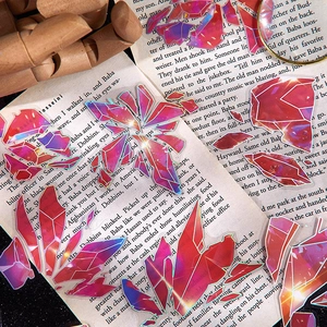Deep red PET crystal stickers with holographic edges on vintage book pages decoration