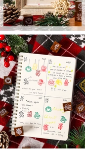 Detailed close-up of Christmas wooden stamps on a journal with festive holiday decor