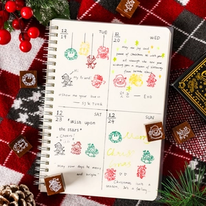9-piece set of wooden Christmas stamps with festive Santa, reindeer, and pine tree patterns