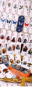 Detail of vintage flower and butterfly poker cards with retro paper texture on fabric