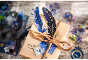 Λεπτομέρεια macro από vintage αυτοκόλλητα φτερών με χρυσότυπο σε ρουστίκ κουτί δώρου