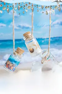 Macro detail of Natural History Museum stickers in creative glass bottles on a beach